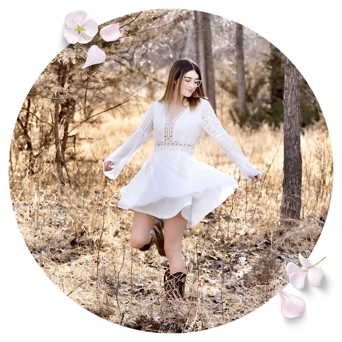Smiling woman in white dress posing for photo in the forest