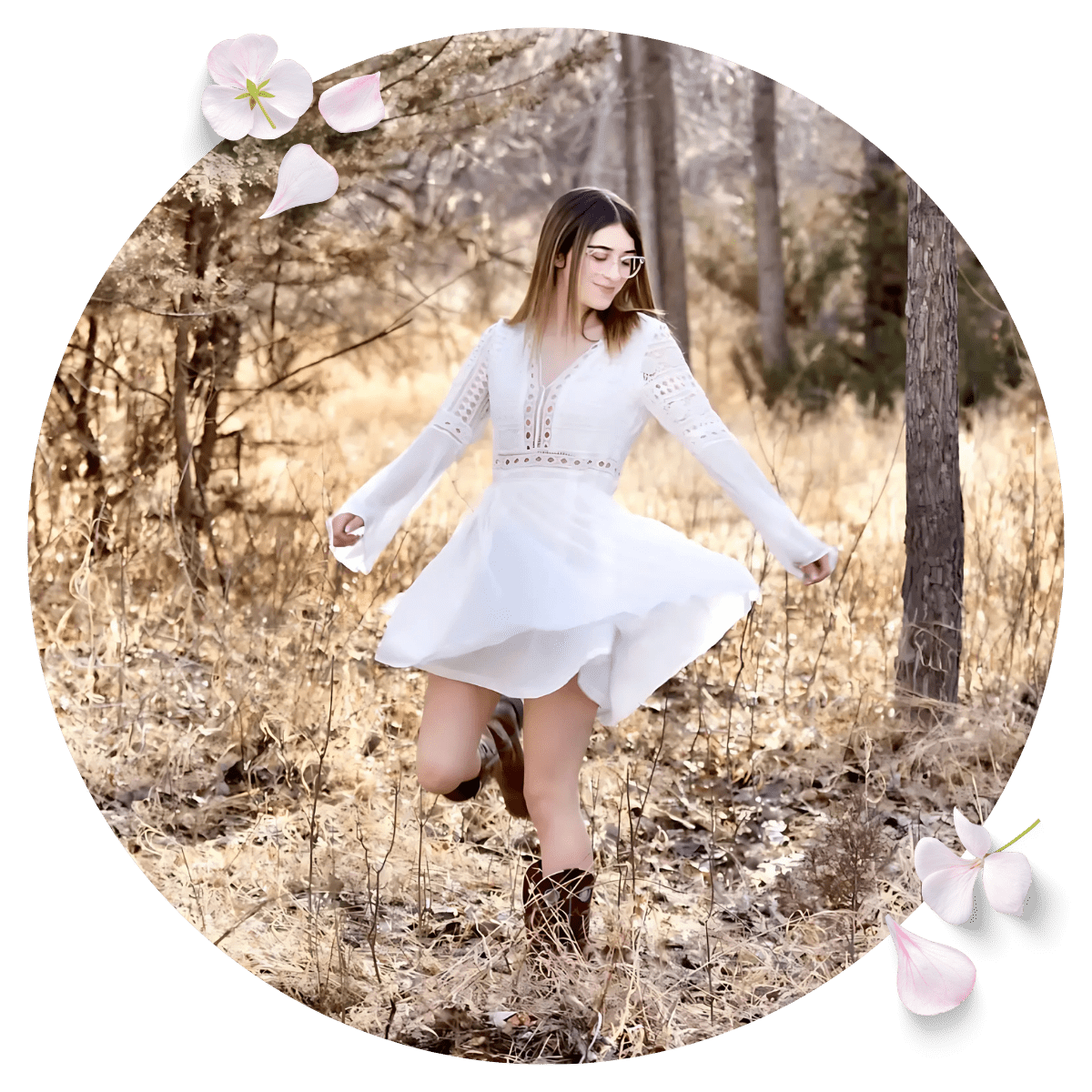 Smiling woman in white dress posing for photo in the forest